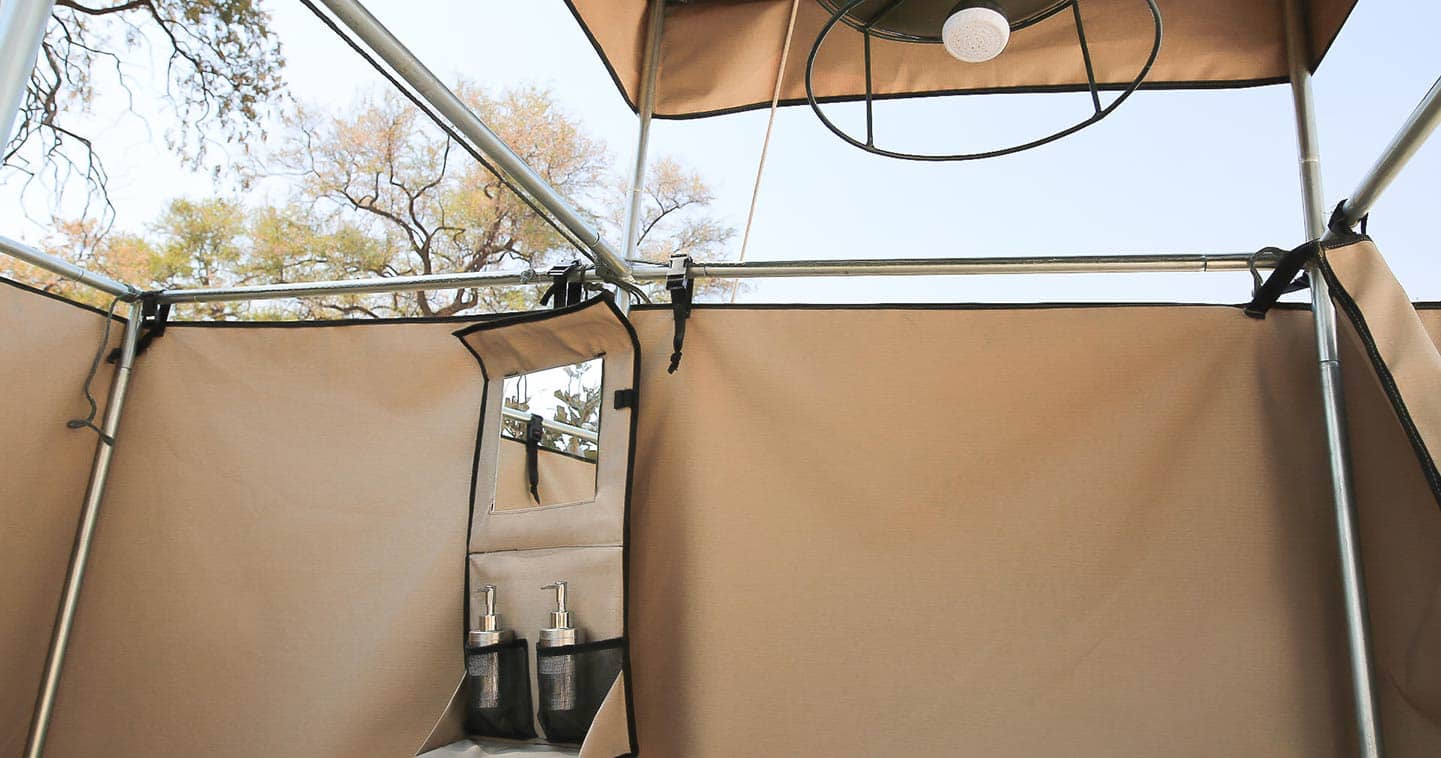 Traditional bucket showers and outdoor bathroom at Feline Fields Camp near Moremi